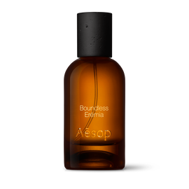 Amber glass Aesop Boundless Eremia Eau de Parfum bottle with black cap on a white background.