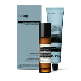 Un frasco con dosificador de Solais Replenishing Hand Serum y un tubo de Reverence Aromatique Hand Balm, presentados juntos en una caja