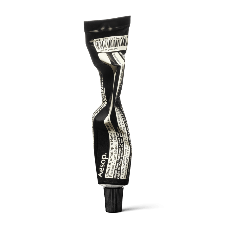 Product sample bottle with black cap on a light background.